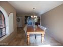 Bright dining room with a large wooden table and access to the kitchen at 7701 S Butte Ave, Tempe, AZ 85284