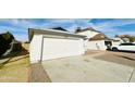 House exterior featuring a white garage door and a gravel driveway at 8728 W Vale Dr, Phoenix, AZ 85037