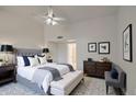Spacious main bedroom featuring a ceiling fan, stylish furnishings, and modern decor at 8728 W Vale Dr, Phoenix, AZ 85037