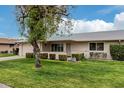 Neatly landscaped exterior of a ranch home with a tree in the front yard at 9601 W Greenhurst Dr, Sun City, AZ 85351