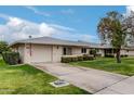 Front view of a ranch home with a driveway and well-kept lawn at 9601 W Greenhurst Dr, Sun City, AZ 85351