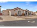 One-story house with a large driveway and desert landscaping at 1040 N 113Th Pl, Mesa, AZ 85207