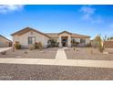 Single-story home with a landscaped front yard and a two-car garage at 1040 N 113Th Pl, Mesa, AZ 85207