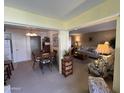 Open dining area with wood table and chairs, offering a view to living room at 10602 W Deanne Dr, Sun City, AZ 85351