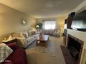 Living room features a neutral color palette, fireplace, and built in shelving at 10602 W Deanne Dr, Sun City, AZ 85351