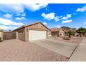 House exterior showcasing a two-car garage and gravel driveway at 13450 W Maui Ln, Surprise, AZ 85379