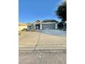 One-story house with gray garage door and desert landscaping at 13622 W Peck Ct, Litchfield Park, AZ 85340
