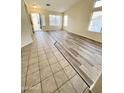 Bright living room with tile and wood-look vinyl flooring at 13622 W Peck Ct, Litchfield Park, AZ 85340