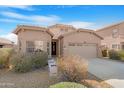 Home featuring low-maintenance desert landscaping, a two car garage, and an inviting front door at 1369 E Linda Dr, Casa Grande, AZ 85122