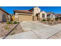 Single-story home with a red door and landscaped front yard at 16744 W Cavedale Dr, Surprise, AZ 85387