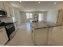 Modern kitchen with granite island, stainless steel appliances, and an open floor plan at 20596 N 226Th Dr, Surprise, AZ 85387