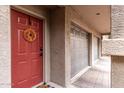 Red front door entry to the unit with a stylish wreath at 4455 E Paradise Village S Pkwy # 1031, Phoenix, AZ 85032