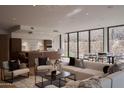 Spacious living area showcasing a modern kitchen, comfortable seating, and seamless indoor-outdoor living at 5000 N Camelback Ridge Rd # 109, Scottsdale, AZ 85251