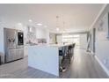 Modern kitchen with large island, white cabinets, and stainless steel appliances at 5120 N 81St St, Scottsdale, AZ 85250