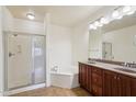 Bathroom with shower, tub, double sink, and vanity with granite countertop at 5450 E Deer Valley Dr # 4015, Phoenix, AZ 85054
