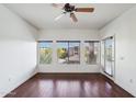 Bright living room featuring hardwood floors, lots of natural light, and a ceiling fan at 5450 E Deer Valley Dr # 4015, Phoenix, AZ 85054