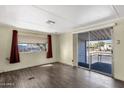 Bright living room with dark wood flooring and sliding glass door at 5933 E Main St # 47, Mesa, AZ 85206