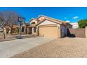 House exterior showcasing a basketball hoop, garage, and side yard at 7248 W Surrey Ave, Peoria, AZ 85381