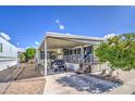 Mobile home with covered patio, golf cart, and brick paver driveway at 7750 E Broadway Rd # 309, Mesa, AZ 85208