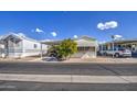 Mobile home with covered parking, a tree, and adjacent homes visible at 7750 E Broadway Rd # 309, Mesa, AZ 85208