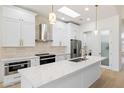Modern kitchen with stainless steel appliances, white cabinets, and a marble countertop island at 7955 E Chaparral Rd # 116, Scottsdale, AZ 85250