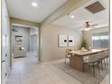 Modern dining area with a table and chairs, overlooking the living room at 9038 W Orchid Ln, Peoria, AZ 85345