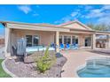 Inviting backyard oasis with a pool, hot tub, and covered patio at 9911 W Jessie Ln, Peoria, AZ 85383