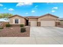 Charming single-story home with a three-car garage and a well-maintained landscaped front yard at 9911 W Jessie Ln, Peoria, AZ 85383