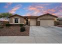 Charming single-story home with a three-car garage and a well-maintained landscaped front yard at 9911 W Jessie Ln, Peoria, AZ 85383