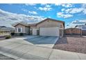 House exterior with a two-car garage and gated entryway at 9911 W Jessie Ln, Peoria, AZ 85383