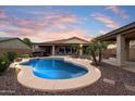 Beautiful backyard featuring a sparkling pool, spa, and covered patio for outdoor entertaining at 9911 W Jessie Ln, Peoria, AZ 85383