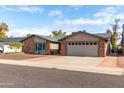 Charming brick and stucco home with a well-manicured front yard and inviting curb appeal at 11427 S Tomah St, Phoenix, AZ 85044