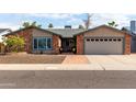 Charming brick and stucco home with a well-manicured front yard and inviting curb appeal at 11427 S Tomah St, Phoenix, AZ 85044