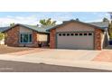 Charming brick and stucco home with a well-manicured front yard and inviting curb appeal at 11427 S Tomah St, Phoenix, AZ 85044