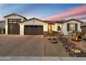 Lovely single-story home showcasing a well-manicured front yard, stone accents, and a spacious three-car garage at 12528 W Tuckey Ln, Glendale, AZ 85307
