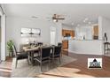 Open dining area with hardwood floors and a view into the kitchen at 15119 W Via Montoya --, Sun City West, AZ 85375