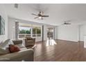 Bright and spacious living room featuring hardwood floors and sliding glass doors at 15119 W Via Montoya --, Sun City West, AZ 85375