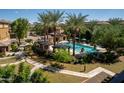 Community pool area surrounded by palm trees, cabanas, and comfortable lounge seating at 17850 N 68Th St # 3120, Phoenix, AZ 85054