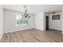 Bright dining room with chandelier, hardwood floors, and access to entryway at 1956 W Black Hill Rd, Phoenix, AZ 85085