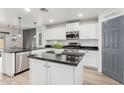 Modern kitchen with white cabinets, granite countertops, and kitchen island at 1956 W Black Hill Rd, Phoenix, AZ 85085