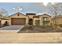 Front view of a single story house with brown garage door and desert landscaping at 19587 W Marshall Ave, Litchfield Park, AZ 85340