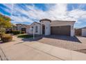 Inviting single-story home showcasing a front yard and a two-car garage at 22235 E Cherrywood Dr, Queen Creek, AZ 85142