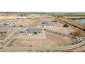 Aerial view showcasing a house's location within a new development, near a lake at 22707 W La Mirada Dr, Buckeye, AZ 85326