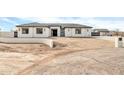 Modern house exterior, featuring a clean white facade and a gray tile roof at 22707 W La Mirada Dr, Buckeye, AZ 85326