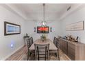 Bright dining room with a large table, six chairs, and a modern light fixture at 2302 N Central Ave # 401, Phoenix, AZ 85004