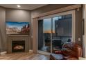 Living room features a fireplace and sliding glass doors leading to a balcony with sunset views at 2302 N Central Ave # 401, Phoenix, AZ 85004