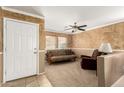 Living room with seating area, a half wall, and neutral-toned decor at 24246 W Tonto St, Buckeye, AZ 85326