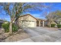 Tan house with arched entryway and two-car garage at 2524 W Saint Catherine Ave, Phoenix, AZ 85041