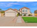 Charming two-story home with a well-manicured lawn and a spacious two-car garage at 3352 E Hopi Ave, Mesa, AZ 85204