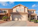 Two-story house with a tan exterior, two-car garage, and landscaped front yard at 4248 E Raven Rd, Phoenix, AZ 85044